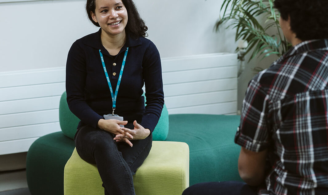 Staff member talking to student